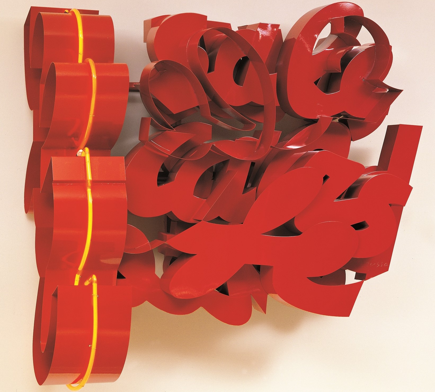 Assemblage made of red aluminium and yellow neon, resembling letters of the alphabet. 