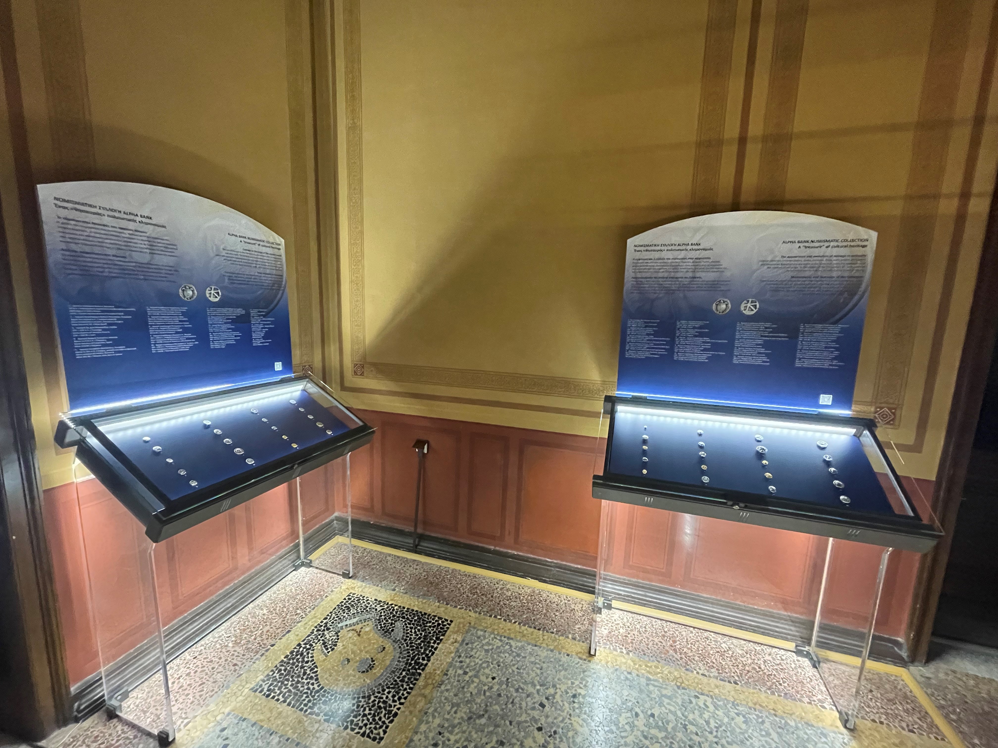 2 blue display cases with the 40 coins of the Alpha Bank Numismatic Collection. The exhibition venue