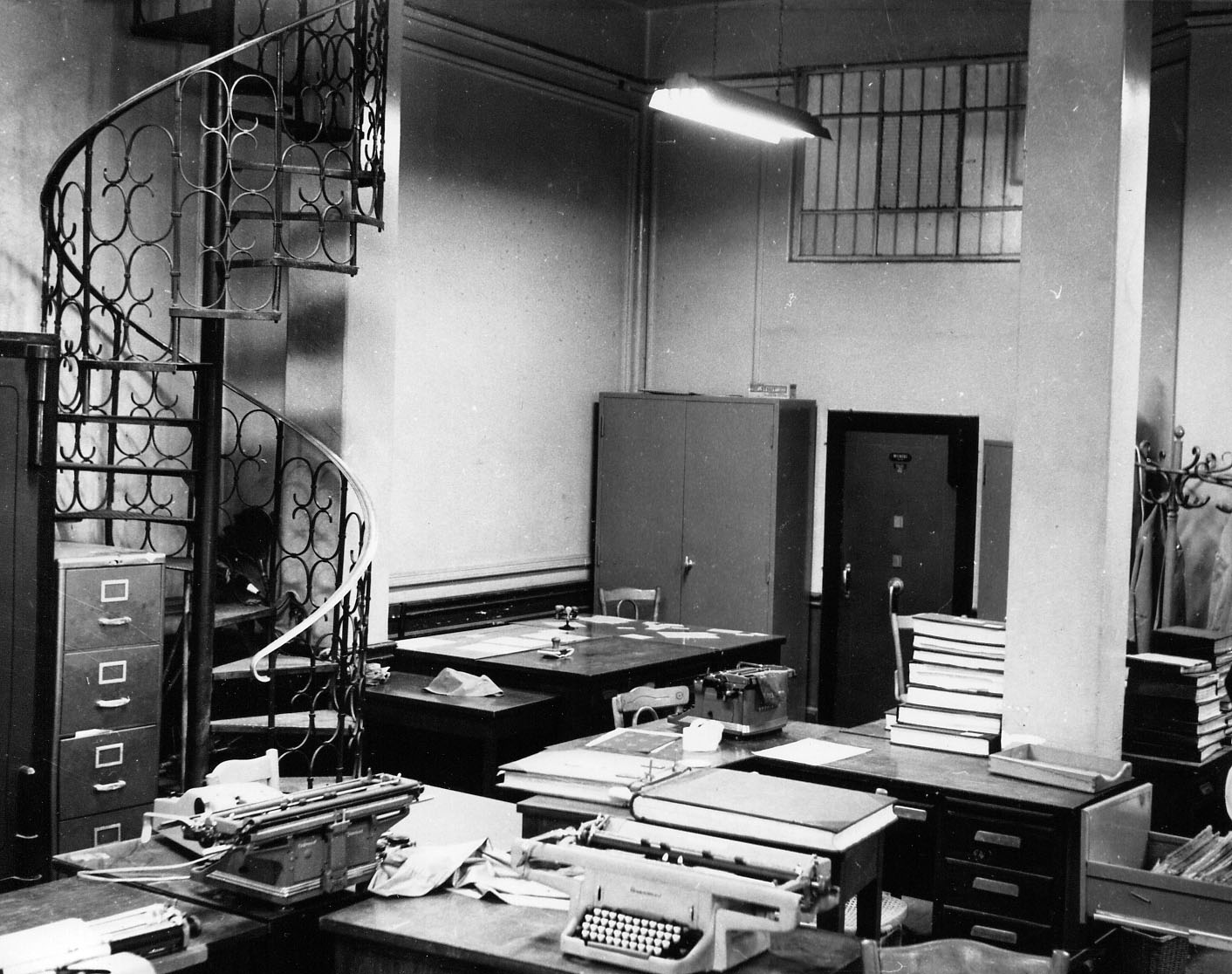 Interior of a Commercial Bank of the Near East branch with desk arrangement and view of the safe.   Interior of a Commercial Bank of the Near East branch