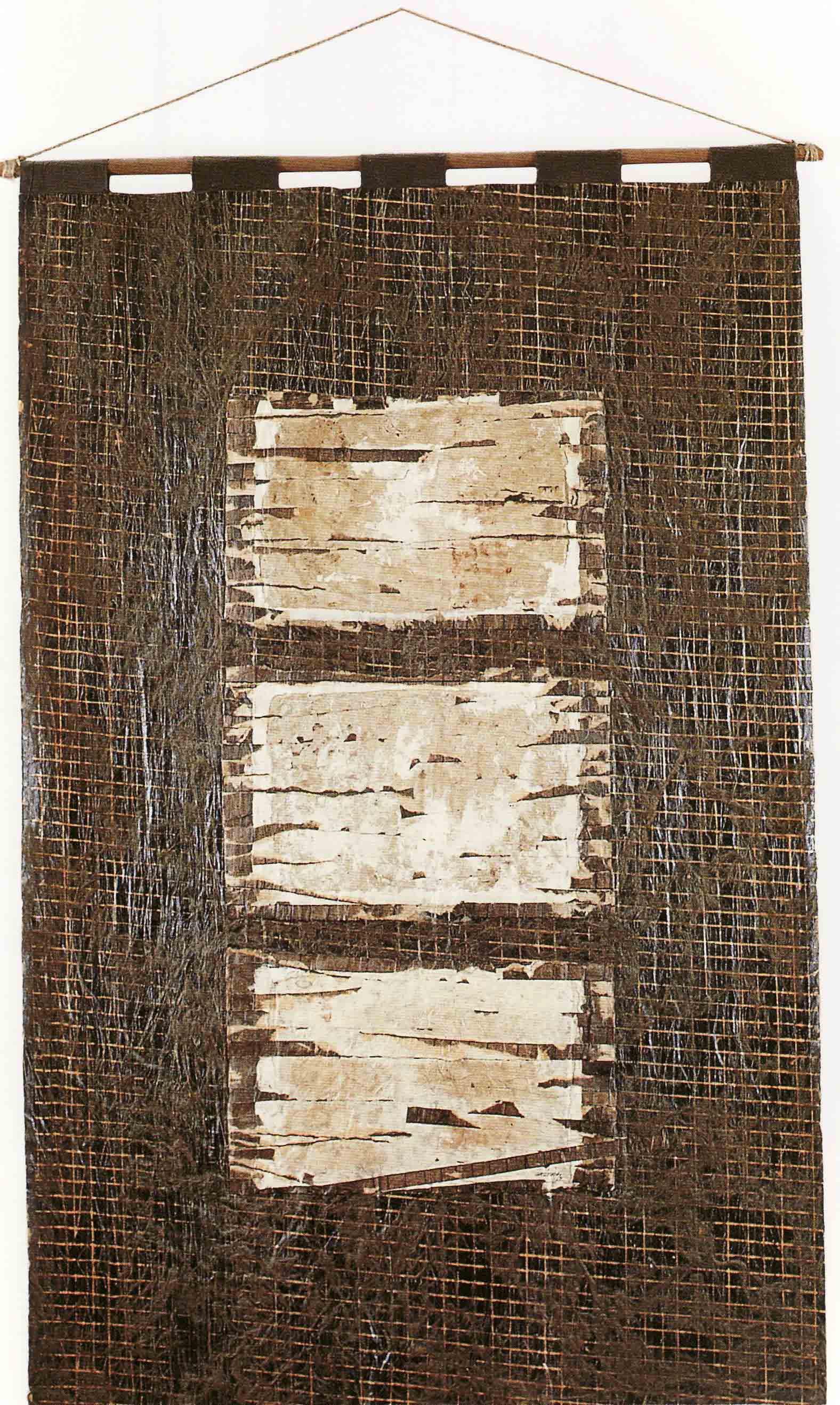 A banner made of dark brown tar paper, with 3 white rectangles one underneath the other.  A banner made of dark brown tar paper, with 3 white rectangles one underneath the other.