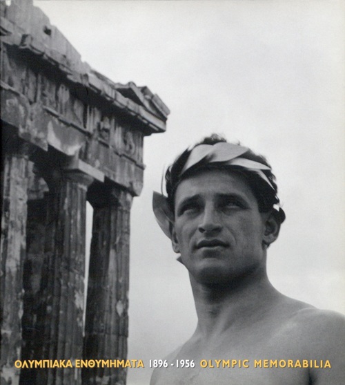 Cover of the publication Olympic Memorabilia 1896-1956 with title and sculpture of an ancient Greek in front of the Acropolis. 