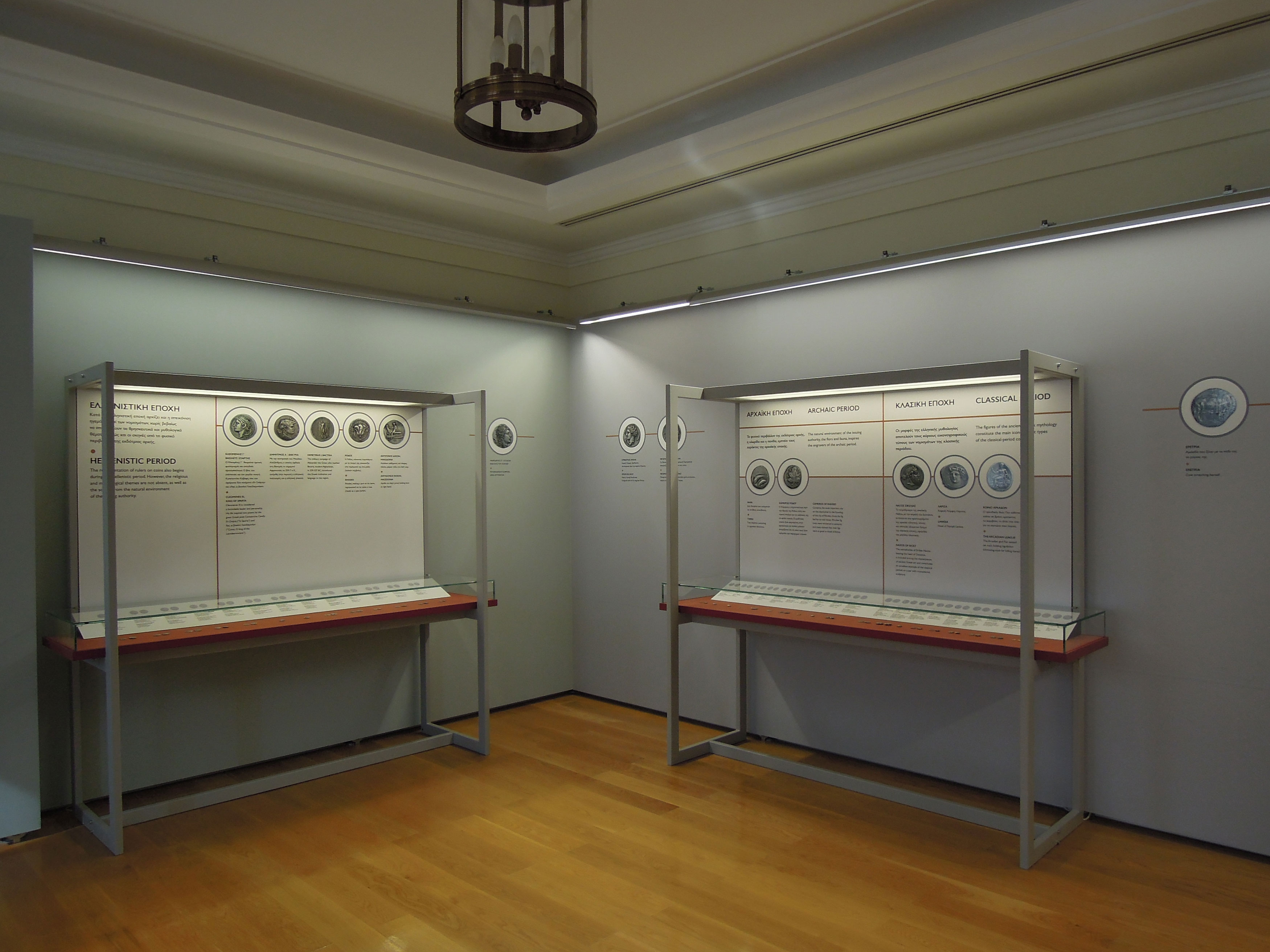 The exhibition area with exhibits in illuminated cases and relevant useful material.  Exhibits “Coins in the Ancient Greek World”