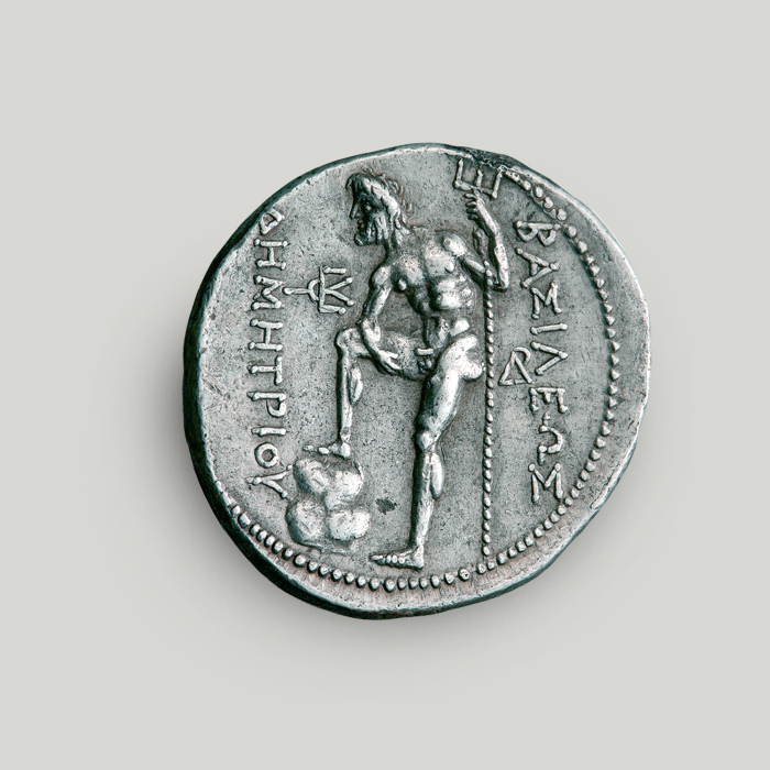 Reverse of silver tetradrachm of Demetrius Poliorcetes depicting Poseidon holding a trident, his foot set on a rock.   Reverse of silver tetradrachm of Demetrius Poliorcetes